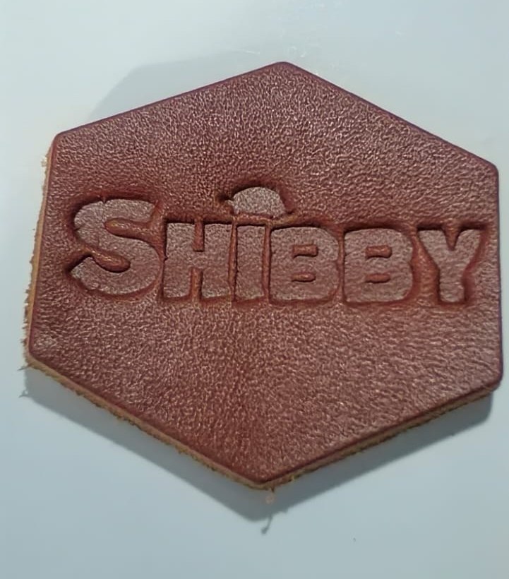 Debossed vegetable leather hexagon patch, sample of Elysian Labels' new custom garment labelling range